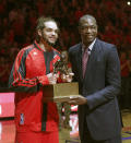 Chicago Bulls center Joakim Noah, left, accepts the 2014 Defensive Player Of The Year Award from Dikembe Mutombo before Game 2 in an opening-round NBA basketball playoff series game against the Washington Wizards Tuesday, April 22, 2014, in Chicago. (AP Photo/Charles Rex Arbogast)