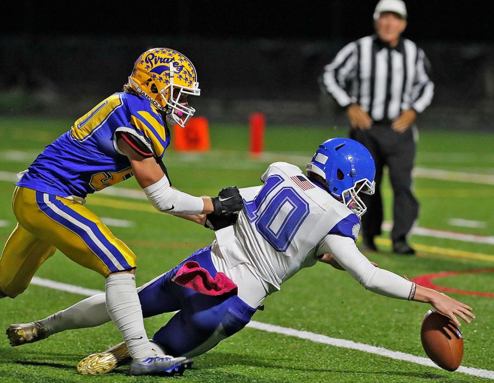 Pirate Sean Reilly forces a fumble but Warrior QB Cory Henderson was able to recover.The Hull Pirates play their first round in the MIAA tournament against the Narragansett Warriors at home on Friday November 4, 2022.