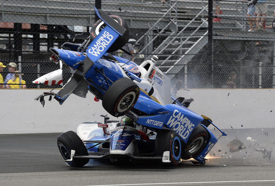 <p>The car driven by Scott Dixon, of New Zealand, goes over the top of Jay Howard, of England, in the first turn during the running of the Indianapolis 500 auto race at Indianapolis Motor Speedway, Sunday, May 28, 2017, in Indianapolis. (Photo: Marty Seppala/AP) </p>