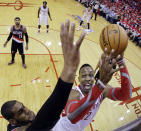 Portland Trail Blazers' LaMarcus Aldridge blocks a shot by Houston Rockets' Dwight Howard during the first half in Game 1 of an opening-round NBA basketball playoff series, Sunday, April 20, 2014, in Houston. (AP Photo/David J. Phillip)