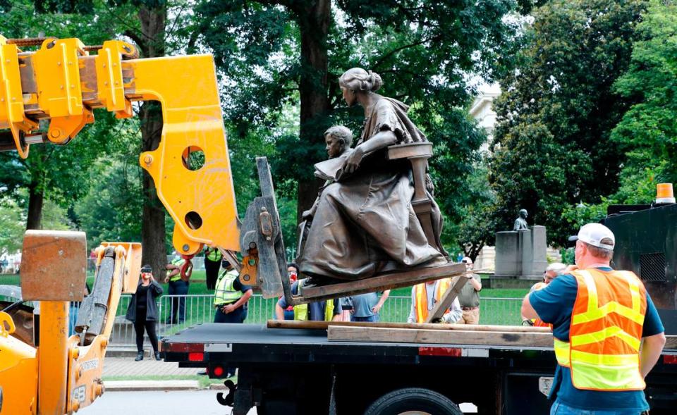 Crews remove the monument to the North Carolina Women of the Confederacy at the North Carolina State Capitol in Raleigh, N.C., Saturday, June 20, 2020.