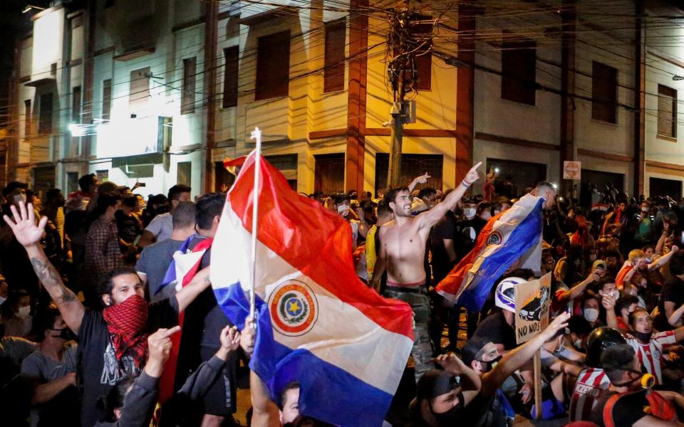 Paraguayans take part in a protest against President Mario Abdo Benitez's health policies and the lack of vaccines - Reuters