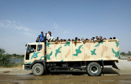 Displaced Iraqi civilians are transported in an army truck after being liberated from scene of battle in the Old City in Mosul, Iraq July 2, 2017. REUTERS/Erik De Castro