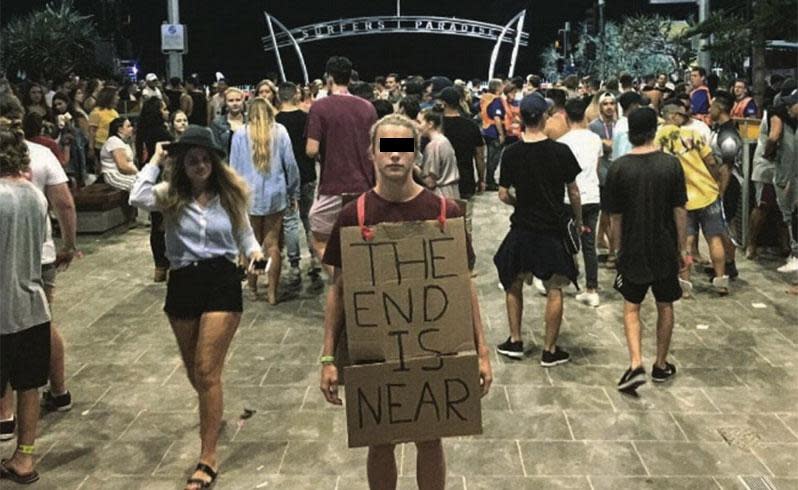 This man held a sign saying, "The end is near" in the middle of Schoolies celebrations. Photo: Facebook