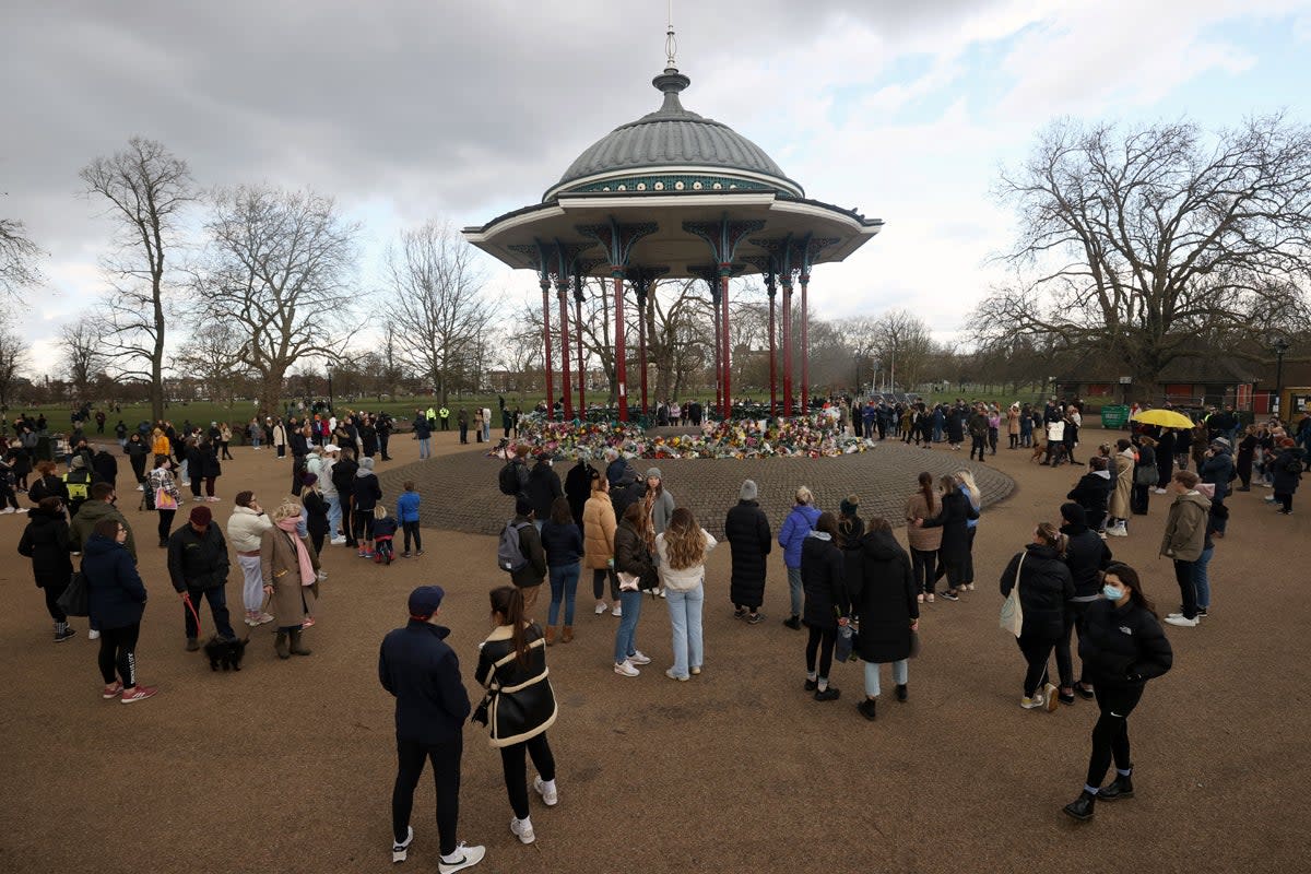 Tributes paid to Sarah Everard at Clapham Common vigil: People gather at a memorial site in Clapham Common Bandstand (Reuters)