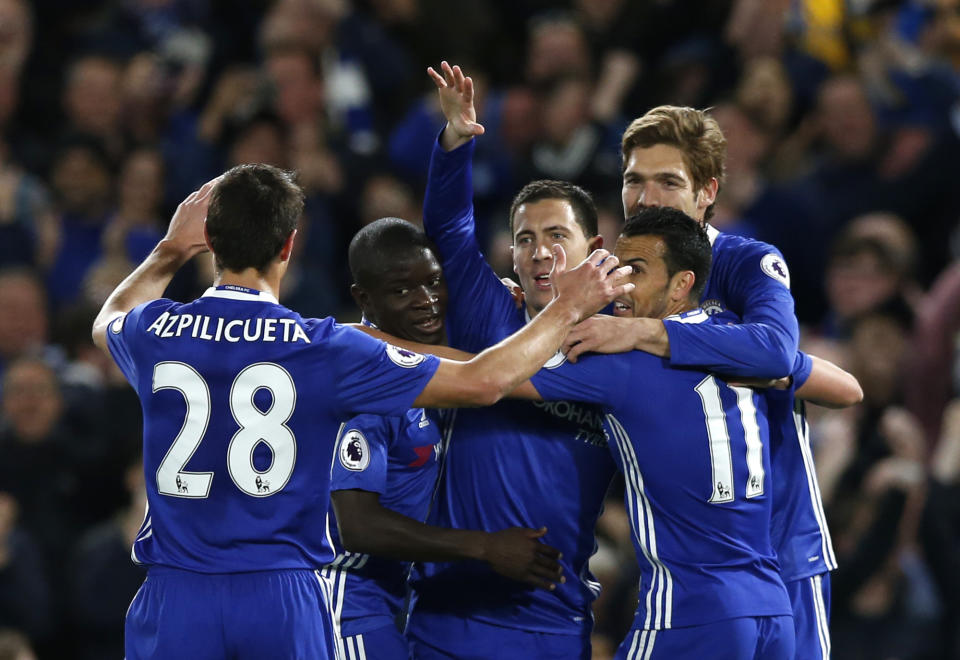 Chelsea players celebrate after Eden Hazard's crucial goal at the Bridge. 