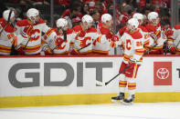 Calgary Flames center Elias Lindholm (28) celebrates with teammates after scoring a the first goal of the first period of an NHL hockey game against the Washington Capitals, Saturday, Oct. 23, 2021, in Washington. (AP Photo/Nick Wass)