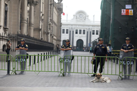 Peruvian police guard near the Government Palace in Lima, Peru March 21, 2018. REUTERS/Guadalupe Pardo