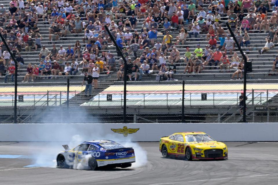 NASCAR Cup Series driver Joey Logano (22) looks to go wide as NASCAR Cup Series driver Chase Elliott (9) spins and clips curbing Sunday, July 31, 2022, during the Verizon 200 at the Brickyard at Indianapolis Motor Speedway.