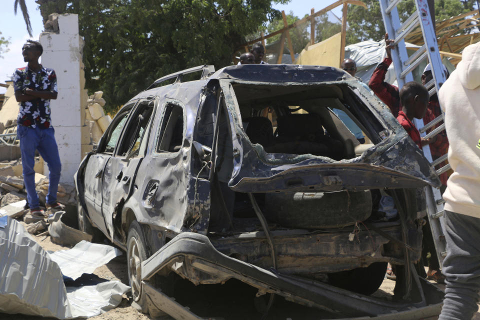 A car destroyed during the attack at Asasey Hotel  in Kismayo, Somalia after the attack Saturday July 13, 2019. Somali forces Saturday morning ended an all-night siege on a hotel in the southern port city of Kismayo, in which the death toll has risen to 26 people, including a prominent Canadian-Somali journalist and several foreigners, officials say.(AP Photo)