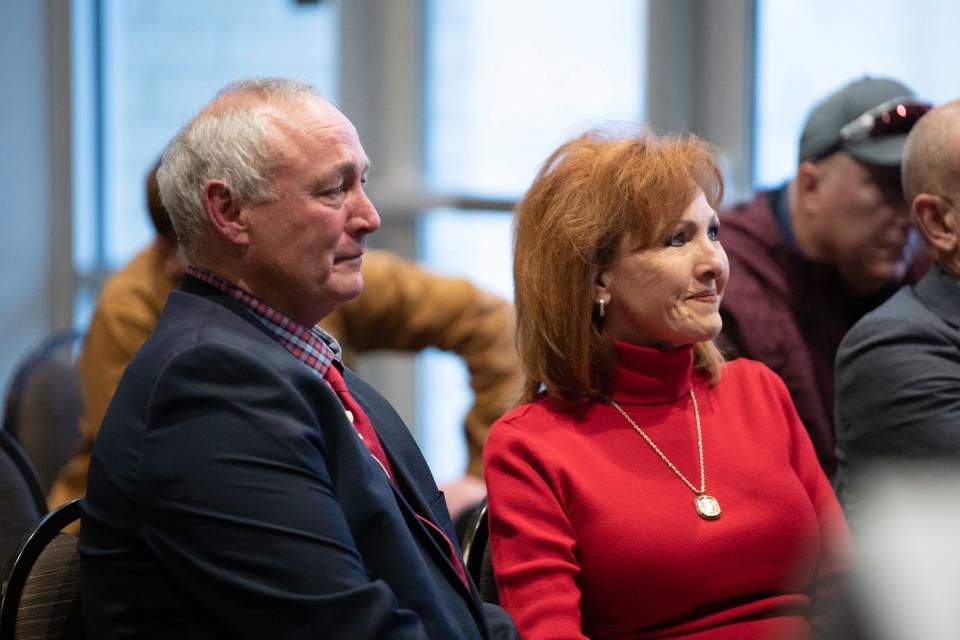 John Wristen and wife Rochelle watch a tribute video during a press conference announcing his retirement as head football coach at Colorado State University Pueblo on Tuesday, Dec. 13, 2022.