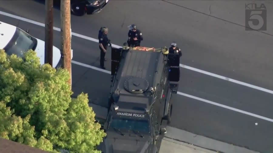 Police officers and SWAT Team members surround a neighborhood after a 13-year-old boy was shot to death in Anaheim on April 17, 2024. (KTLA)