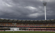 Players watch as rain clouds gather during play on day two of the fourth cricket test between India and Australia at the Gabba, Brisbane, Australia, Saturday, Jan. 16, 2021. (AP Photo/Tertius Pickard)