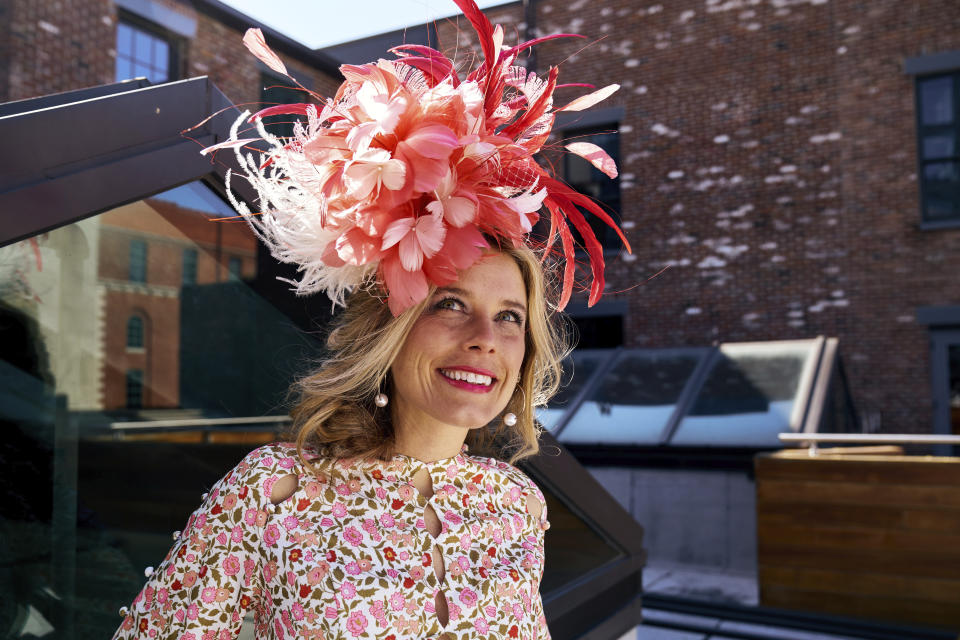 FILE - In this undated photo provided by Jessa Mayhew in April 2020, hat maker Kenzie Kapp models one of her fascinator designs for the Kentucky Derby in Louisville, Ky. The Kentucky Derby is back on the first Saturday in May 2021, slowly bringing with it the sights, sounds and rituals familiar to Louisville. And local officials and business owners are hopeful it translates into better cash flow after the coronavirus pandemic upended the Derby’s schedule the previous year. “It definitely smells like Derby,” said business owner and Louisville native Kapp, who’s relishing a boost in demand making masks to match her hats and fascinators. (Jessa Mayhew via AP)