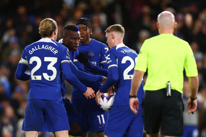 Noni Madueke,nicolas Jackson and Cole Palmer of Chelsea argue over a penalty kick during the Premier League match between Chelsea FC and Everton FC at Stamford Bridge on April 15, 2024