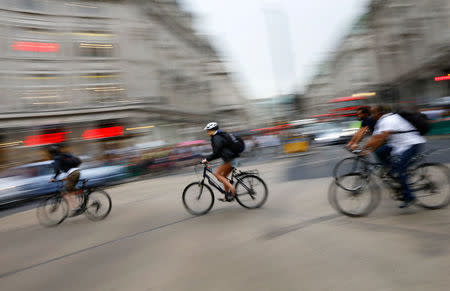 FILE PHOTO: Commuters cycle through Oxford Circus in London, Britain, August 5, 2015. REUTERS/Darren Staples/File Photo