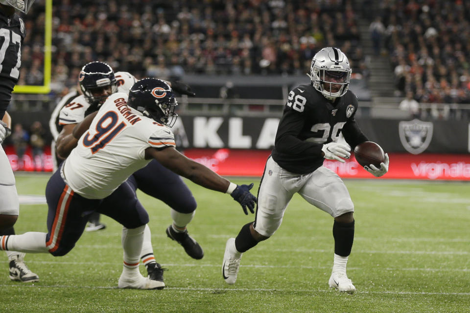 Oakland Raiders running back Josh Jacobs (28) runs past Chicago Bears nose tackle Eddie Goldman (91) for a touchdown during the first half of an NFL football game at Tottenham Hotspur Stadium, Sunday, Oct. 6, 2019, in London. (AP Photo/Tim Ireland)