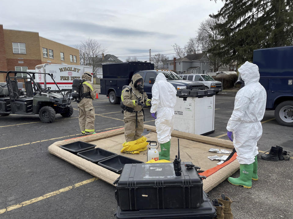 This photo provided by the Ohio National Guard, ONG 52nd Civil Support Team members prepare to enter an incident area to assess remaining hazards with a lightweight inflatable decontamination system (LIDS) in East Palestine, Ohio, Tuesday, Feb. 7, 2023. Authorities say air monitoring hasn’t detected dangerous levels of fumes in communities where crews released and burned toxic chemicals from a derailed train. But they said Tuesday that Ohio and Pennsylvania residents living close to the wreckage still aren’t being allowed in their homes.(Ohio National Guard via AP)