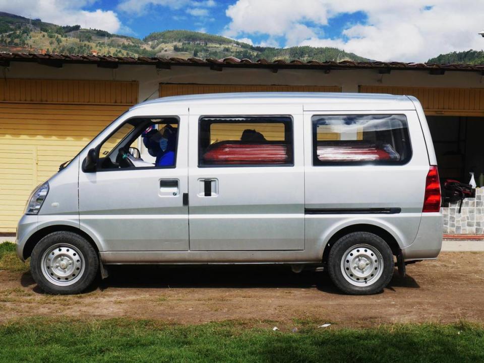 Workers prepare to transport a coffin carrying the remains of a man who died from COVID-19 for burial at a cemetery in Cajamarca, Peru, on May 9, 2021.