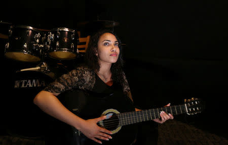 A woman plays music in a dark, soundproof room in an effort to relieve frustration and escape from the stresses of daily life in the new "scream room" inside a bookshop in Cairo, Egypt October 23, 2016. REUTERS/Mohamed Abd El Ghany