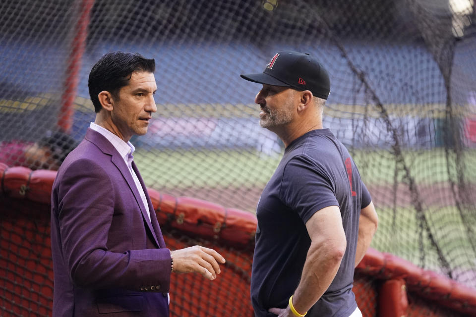 Arizona Diamondbacks manager Torey Lovullo, right, talks with Diamondbacks general manager Mike Hazen before Game 3 of a baseball NL Division Series against the Los Angeles Dodgers, Wednesday, Oct. 11, 2023, in Phoenix. (AP Photo/Ross D. Franklin)