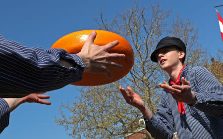 Sellers throw Gouda wheels at the cheese market in Gouda, Netherlands April 18, 2019. REUTERS/Yves Herman