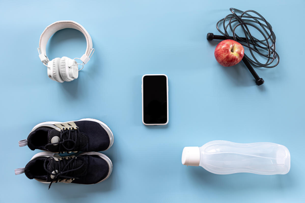 Flat lay composition with items for sports, training, keeping fit on blue isolated, for NHS weight loss app (Getty Images)