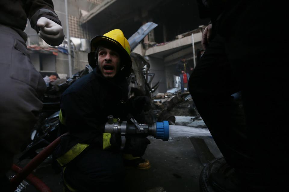 Firefighters attempt to extinguish a fire following an explosion in Beirut's southern suburbs