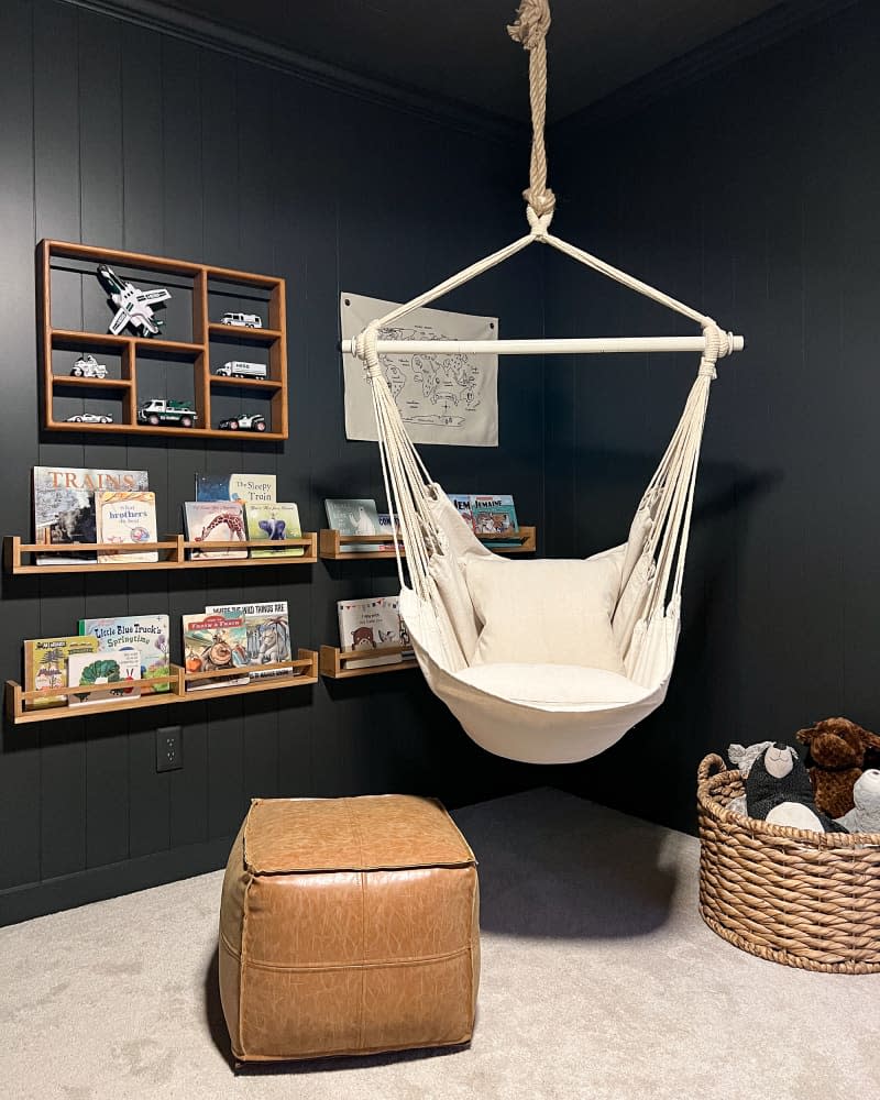 Swing in child's room with black walls.