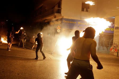 Masked demonstrators throw petrol bombs to riot police during a rally marking four years since the fatal stabbing of Greek anti-fascism rapper Pavlos Fyssas by a supporter of the ultranationalist Golden Dawn party in Athens, Greece, September 16, 2017. REUTERS/Alkis Konstantinidis