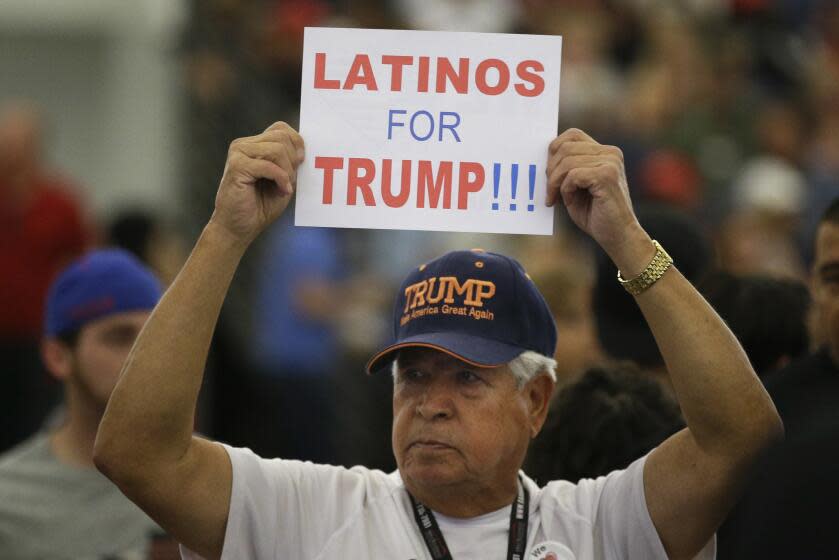 FILE - In this May 25, 2016, file photo, a man holds up a sign for then-Republican presidential candidate Donald Trump before the start of a rally at the Anaheim Convention Center, Wednesday, May 25, 2016, in Anaheim, Calif. Republicans are holding onto a steady share of the Latino vote in the Trump era. With a president who targets immigrants from Latin America, some analysts predicted a Latino backlash against the GOP. But it hasn't happened. Data from AP's VoteCast survey suggests Republicans are holding on to support from Latino evangelicals and veterans. (AP Photo/Jae C. Hong, File)