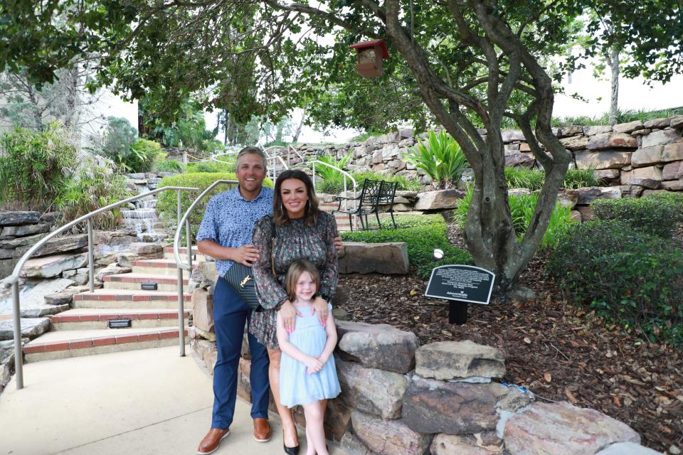 Ryan, Kait and Palmer Gray stand in front of McKenzie’s Moment Garden at the AdventHealth Ocala unveiling on June 14.