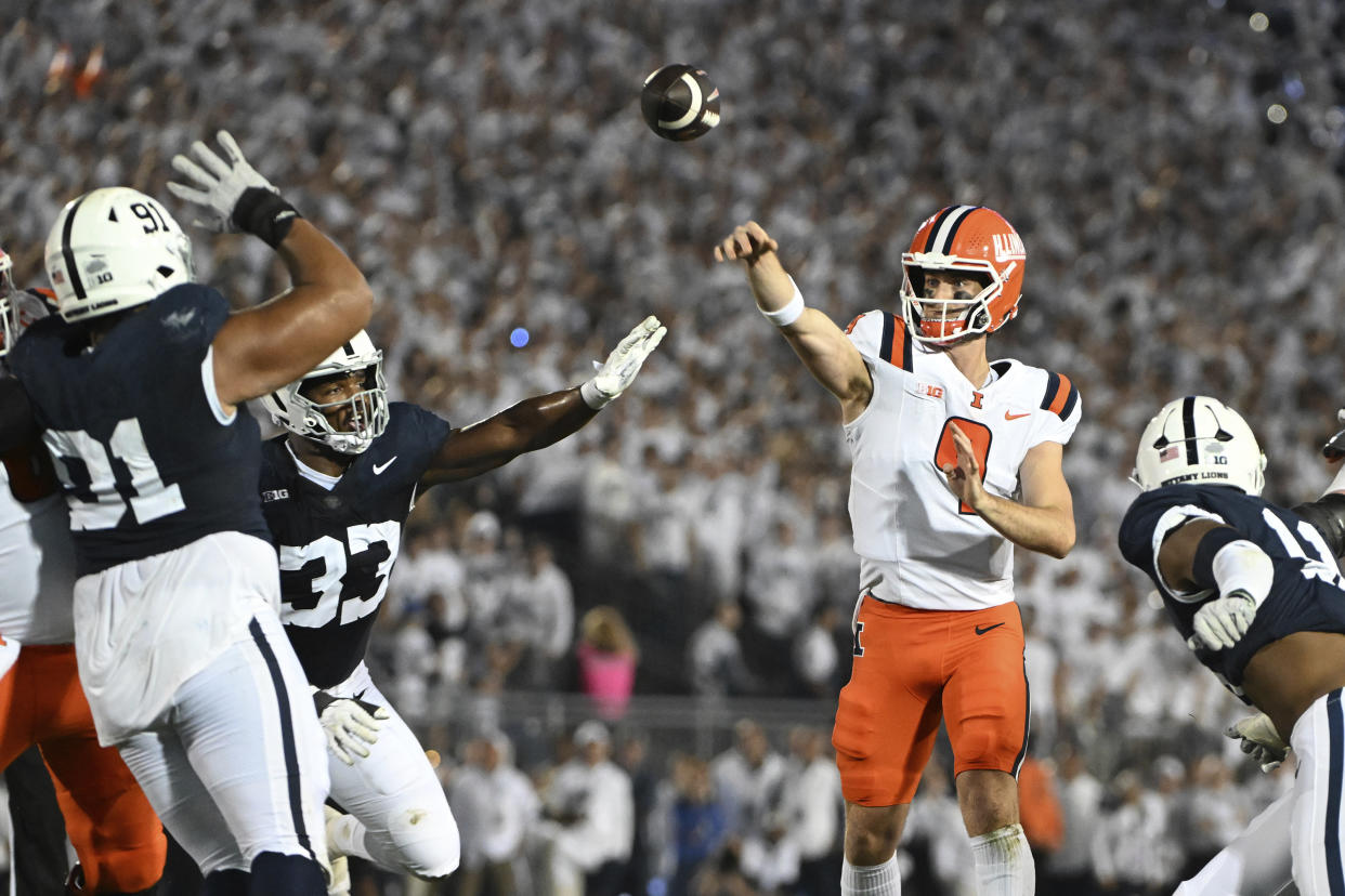 Illinois quarterback Luke Altmyer (9) throws a pass over Penn State defensive tackle Dvon J-Thomas (91) during the first quarter of an NCAA college football game, Saturday, Sept. 28, 2024, in State College, Pa. (AP Photo/Barry Reeger)