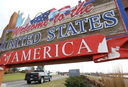 A car bound for the United States from Canada passes a welcome sign in Blaine, Washington, U.S. February 16, 2017. REUTERS/Chris Helgren