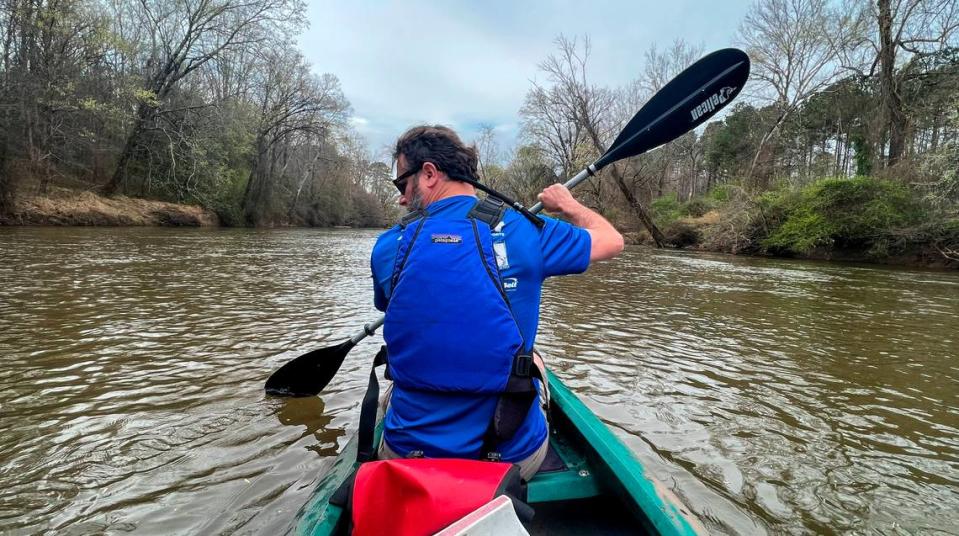 News & Observer photojournalist Travis Long paddles the Neuse River near Raleigh.