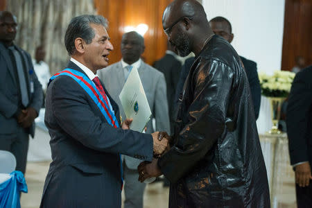 The Special Representative of the Secretary-General and Head of UNMIL, Farid Zarif, is honoured by Liberia's President, George Weah, during the official celebration of the completion of the UNMIL Mandate in Monrovia, Liberia March 22, 2018. Albert Gonzalez Farran/UNMIL/Handout via REUTERS THIS IMAGE HAS BEEN SUPPLIED BY A THIRD PARTY. NO RESALES. NO ARCHIVES