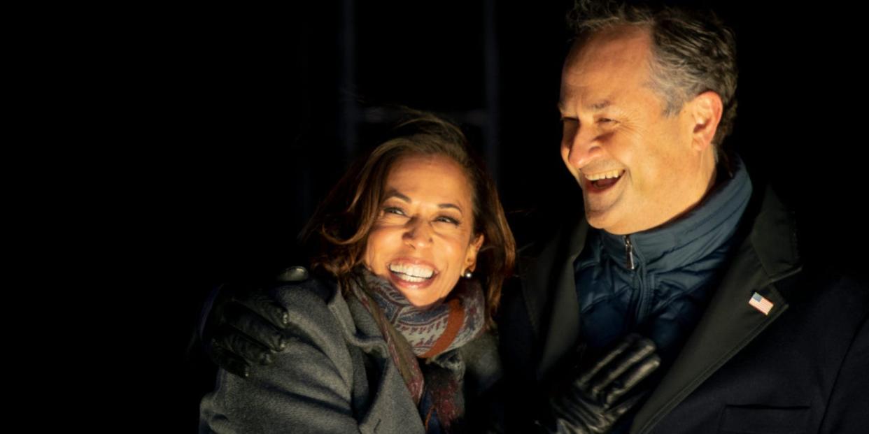 PHILADELPHIA, PA - NOVEMBER 02: Democratic vice presidential nominee Sen. Kamala Harris (D-CA) and husband, Douglas Emhoff, embrace on stage after Democratic presidential nominee Joe Biden spoke in Pittsburgh at a simultaneous drive-in election eve rally on November 2, 2020 in Philadelphia, Pennsylvania. Democratic presidential nominee Joe Biden, who is originally from Scranton, Pennsylvania, remains ahead of President Donald Trump by about six points, according to a recent polling average. With the election tomorrow, Trump held four rallies across Pennsylvania over the weekend, as he vies to recapture the Keystone State's vital 20 electoral votes. In 2016, he carried Pennsylvania by only 44,292 votes out of more than 6 million cast, less than a 1 percent differential, becoming the first Republican to claim victory here since 1988. (Photo by Mark Makela/Getty Images)