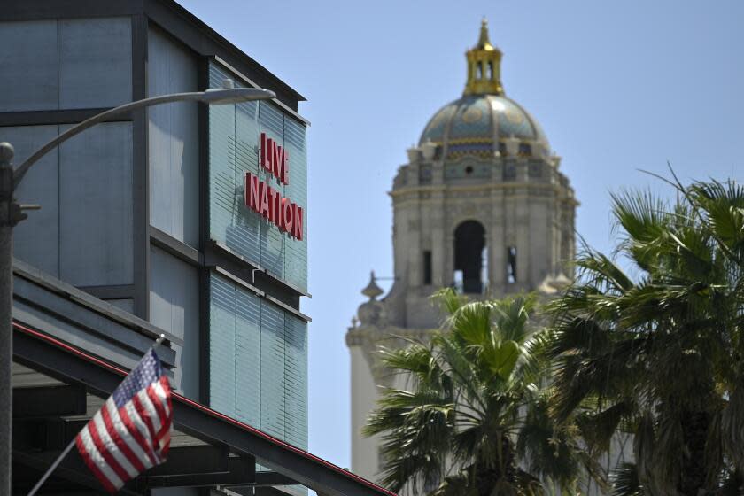 HOLD FOR STORY BY WILLIAM J. KOLE - The headquarters of Live Nation is seen at left, near Beverly Hills City Hall, Monday, June 29, 2020, in Beverly Hills, Calif. America's nightclubs are largely closed because of the coronavirus pandemic, but that isn't stopping an interfaith coalition from launching a campaign to stop what organizers call the "disrespectful" use of Buddhist and Hindu statues as upscale decor. Representatives of the Buddhist, Hindu, Jain, Jewish and Christian traditions have formed an improbable alliance to end the practice, starting with upmarket clubs in Boston and other cities that are managed by Live Nation, a Beverly Hills, California-based entertainment conglomerate. (AP Photo/Mark J. Terrill)