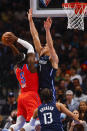 Oklahoma City Thunder forward Luguentz Dort (5) attempts to shoot as Dallas Mavericks forward Dwight Powell (7) and guard Jalen Brunson (13) defend during the first half of an NBA basketball game, Monday, Jan. 17, 2022, in Dallas. (AP Photo/Brandon Wade)