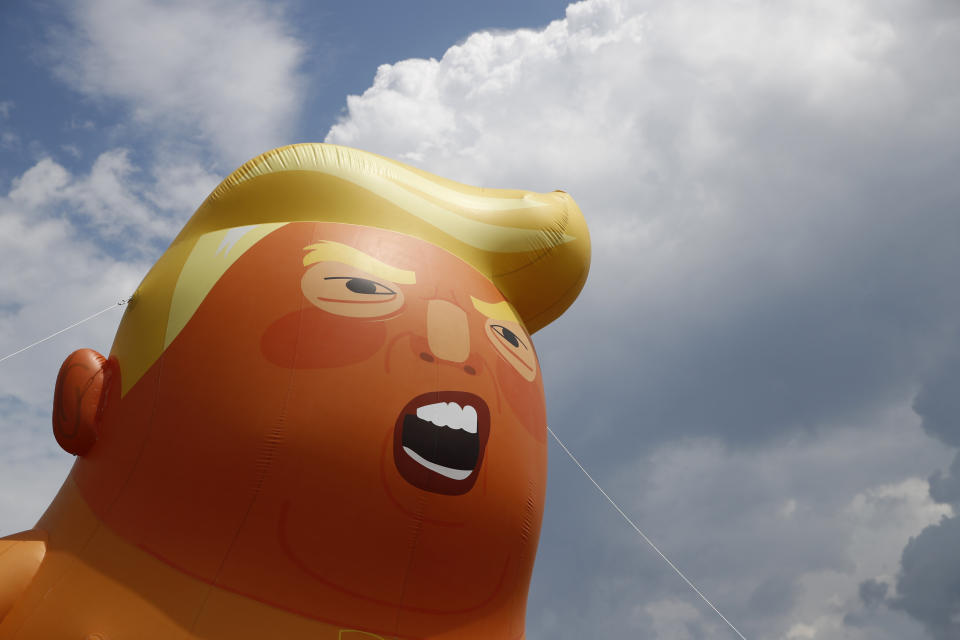 The infamous Trump baby blimp was on hand for part of the day in protest of the president. (Photo: ASSOCIATED PRESS)