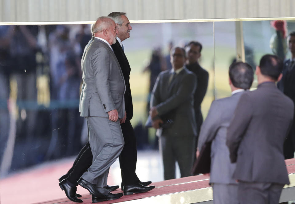 Brazilian President Luiz Inacio Lula da Silva, front left, and Argentine President Alberto Fernandez enter the Alvorada palace in Brasilia, Brazil, Tuesday, May 2, 2023. (AP Photo/Gustavo Moreno)