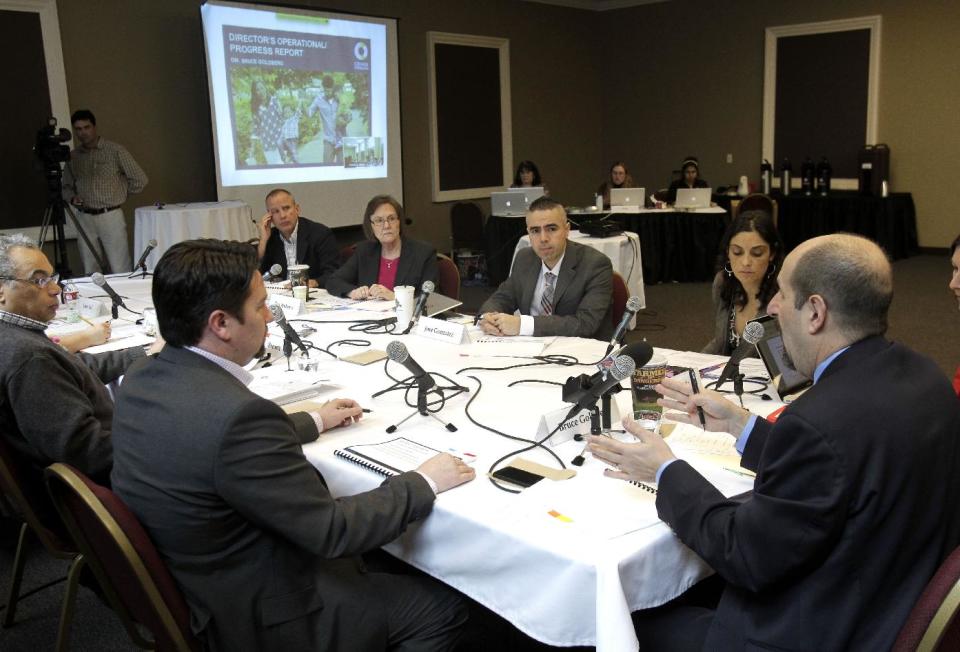 FILE - In this March 13, 2014 file photo, Cover Oregon Executive Director Dr. Bruce Goldberg, right, speaks during a Cover Oregon board meeting in Portland, Ore., Thursday, March 13, 2014. A federal government report on Oregon's botched health insurance exchange faults the state's main information technology contractor for not providing key information to Cover Oregon and blames the exchange for lax management. (AP Photo/Don Ryan)