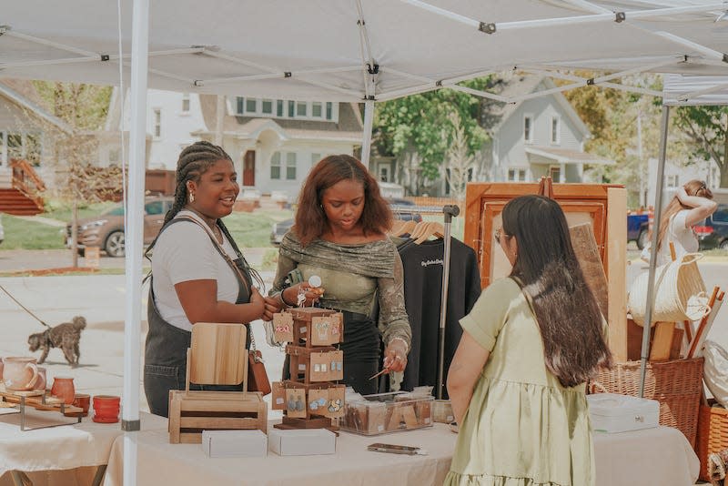 Customers visit with a vendor during the Beautiful Land Pop-up Market in May. The next market will be held from 11 a.m. to 4 p.m. Sunday in the downtown Fareway parking lot.