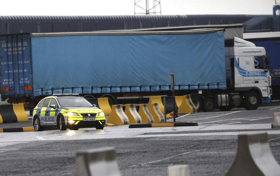 Police patrol the port of Larne, Northern Ireland, Tuesday, Feb. 2, 2021. Authorities in Northern Ireland have suspended checks on animal products and withdrawn workers from two ports after threats against border staff. (AP Photo/Peter Morrison)