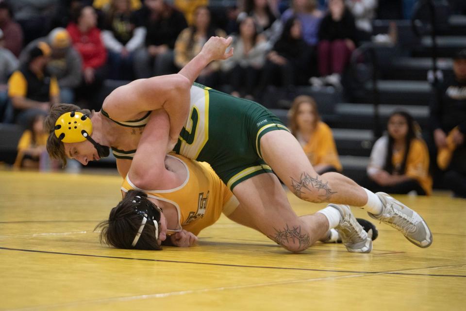 Pueblo County's Tony Macaluso works to roll Pueblo East's Kael Gonzales during their 144-pound matchup on Wednesday, January 3, 2024.