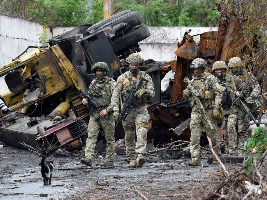 Russian troops patrol the destroyed part of the Ilyich Iron and Steel Works in Ukraine's port city of Mariupol on May 18, 2022, amid ongoing Russian military action in Ukraine.