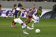 Fenerbahce's Dusan Tadic scores from penalty against Olympiakos during the Europa Conference League quarter final first leg soccer match between Olympiacos and Fenerbahce at the Georgios Karaiskakis stadium, Piraeus port near Athens, Greece, Thursday, April 11, 2024. (AP Photo/Thanassis Stavrakis)