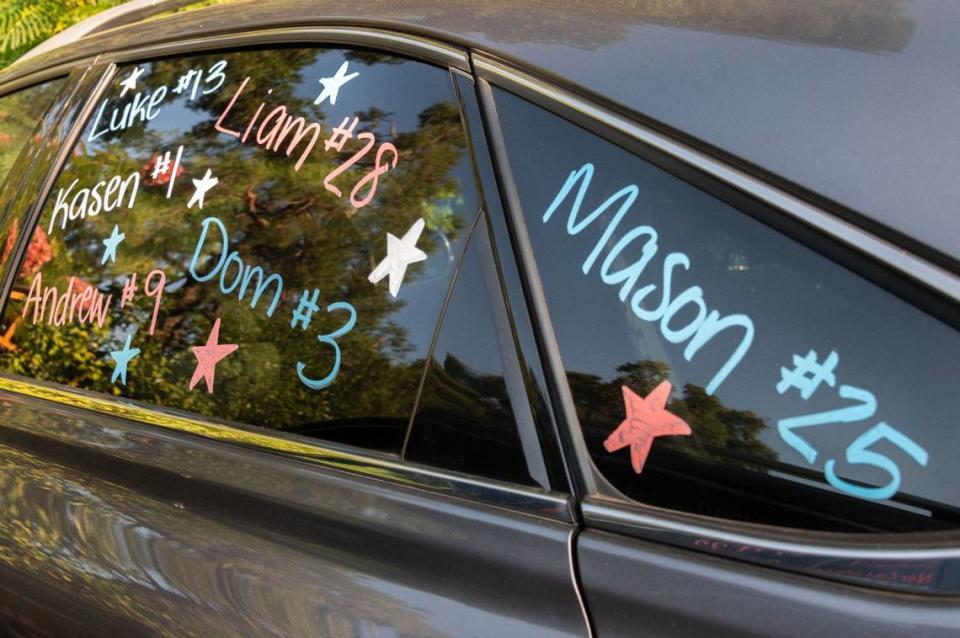Players’ names and jersey numbers adorn the windows of a car in the parking lot of Dooley Field in Sacramento on Monday, July 29, 2024. “Not only do they have the knowledge, skills and abilities, but the bond that they have is so sweet,” Lilly Wyatt, mother of pitcher and slugger Luke Wyatt, said.