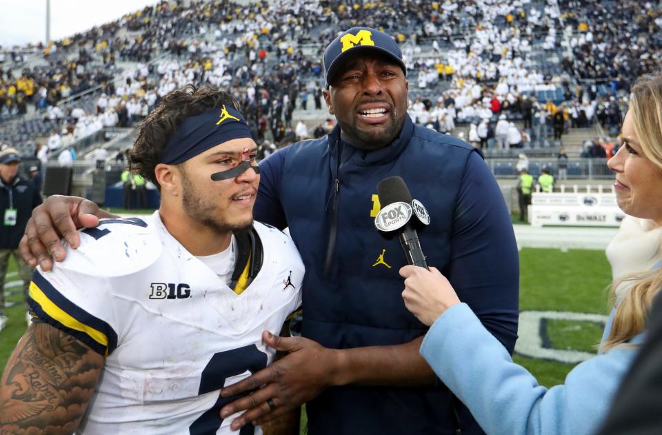 Michigan offensive coordinator and acting head coach Sherrone Moore reacts while being interviewed with running back Blake Corum following the 24-15 win over Penn State on Saturday, Nov. 11, 2023, in University Park, Pennsylvania.