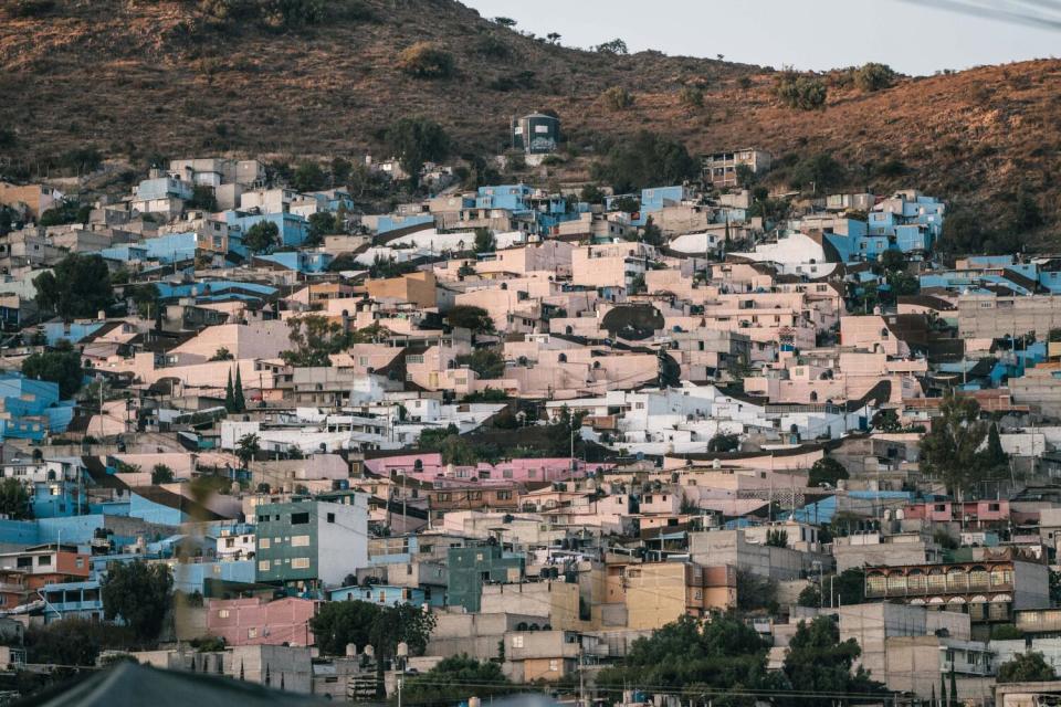 A view of homes in a neighborhood painted to depict the likeness of a cartoon character with a white mustache